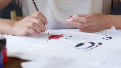 Woman-Creating-Fashion-Illustration-on-T-Shirt