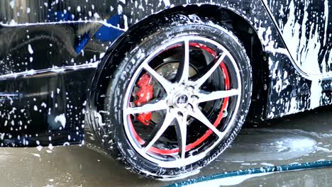 Car-with-white-soap-on-the-body.-car-wash-concept.-Slow-motion