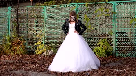 A-bride-with-a-creepy-skull-makeup-for-Halloween-in-an-abandoned-city.