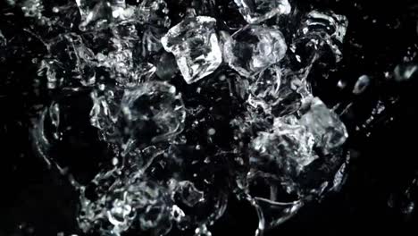 Falling-of-cubes-of-ice-on-a-black-background.-Slow-motion.