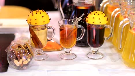 Mulled-wine,-hot-tea-with-cinnamon-and-orange-juice-on-table.-Furshet-of-hot-drinks-in-celebration-of-New-Year-party-and-delicious-Christmas-drink-for-winter-season