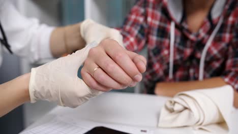 The-doctor-examines-an-x-ray-of-the-damaged-wrist-of-the-patient.-The-doctor-examines-the-patient's-arm.-Doctor-inspects-injury