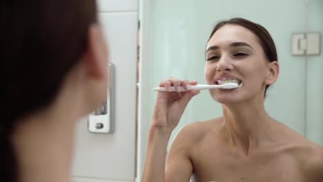 Dental-Health.-Woman-Brushing-Teeth-In-Bathroom