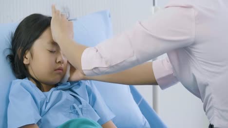 Father-is-taking-care-his-daughter-on-the-bed-in-hospital.