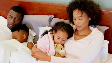 Front-view-of-black-family-sleeping-in-bedroom-at-home-4k