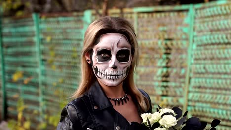 Creepy-bride-with-a-bouquet-of-black-flowers-and-make-up-in-the-form-of-a-skull