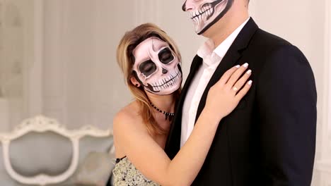 Halloween.-A-couple-with-makeup-on-their-face-in-a-room-with-a-vintage-interior.