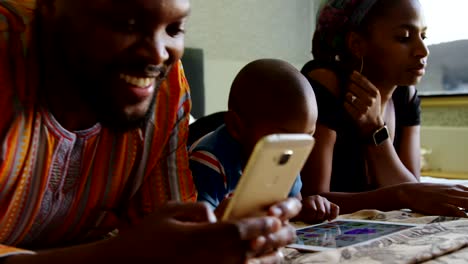 Family-using-multimedia-devices-on-bed-in-a-comfortable-home-4k