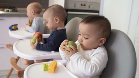 Asian-Triplets-Playing-with-Whole-Apples