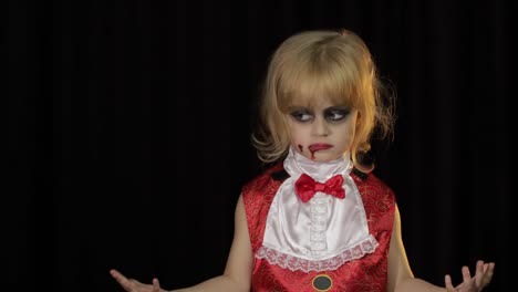 Dracula-child.-Girl-with-halloween-make-up.-Vampire-kid-with-blood-on-her-face