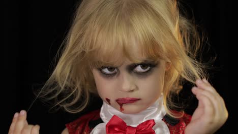 Dracula-child.-Girl-with-halloween-make-up.-Vampire-kid-with-blood-on-her-face