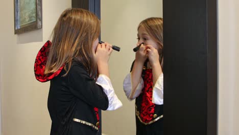 girl-painting-her-face-for-Halloween-laughing