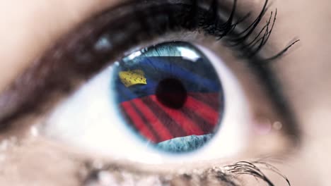 woman-blue-eye-in-close-up-with-the-flag-of-Liechtenstein-in-iris-with-wind-motion.-video-concept