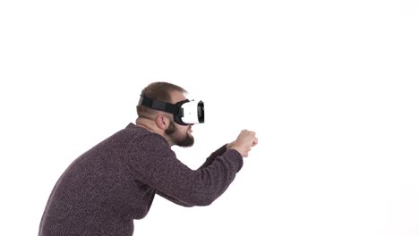 Man-imitates-driving-car-in-virtual-reality-glasses.-Cool-high-tech-devices-usage-concept.