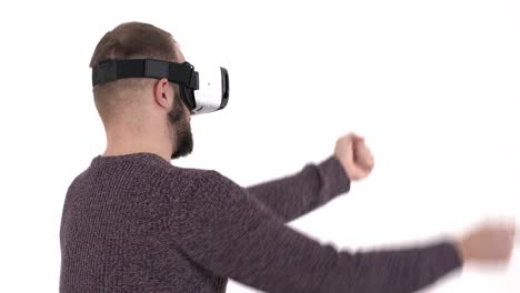 Man-imitates-driving-car-in-virtual-reality-glasses.-3d-cyberspace-simulation-concept