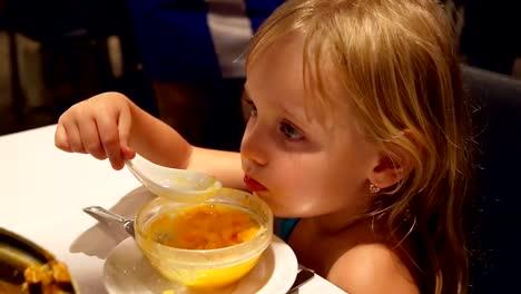 Child-little-girl-eating-dessert-by-spoon.