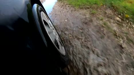 Car-Wheel-Driving-Through-Deep-Puddle-Slow-Motion-POV