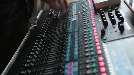 Music-mixing-console.-The-man-tunes-the-sound