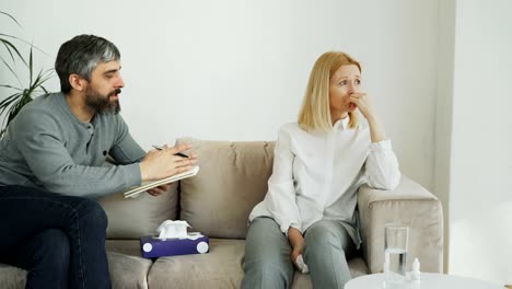 Crying-stressed-woman-talking-with-professional-male-psychoanalyst-who-trying-to-calm-her-down-during-thearpy-session