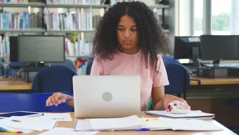 Female-Student-Working-On-Computer-In-College-Library