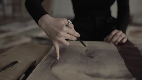 Close-up-of-womans-hand-painting-in-her-studio