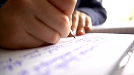 Child-hands-writing-a-letter,-close-up-slow-motion