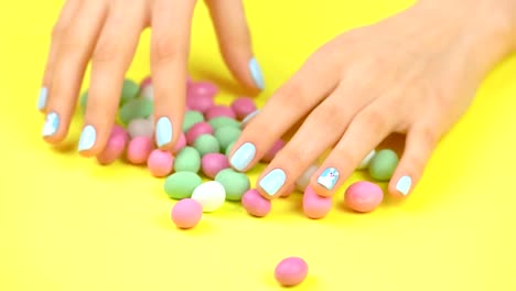 Colorful-candies-and-woman-manicured-hands.