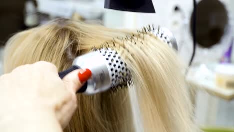 Process-of-making-hairstyle-with-hairdryer-and-brush