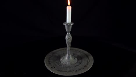 time-lapse-of-white-burning-candle-in-an-antique-victorian-silver-candle-holder