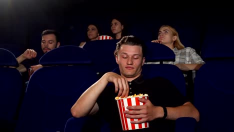 Handsome-man-falling-asleep-during-movie-at-the-cinema