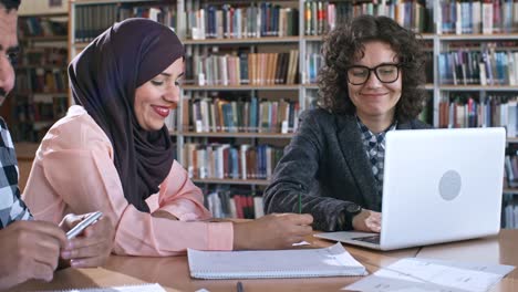 Muslim-Woman-and-Female-Teacher-Using-Laptop-at-Lesson