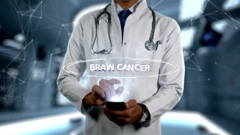 Brain-Cancer---Male-Doctor-With-Mobile-Phone-Opens-and-Touches-Hologram-Illness-Word