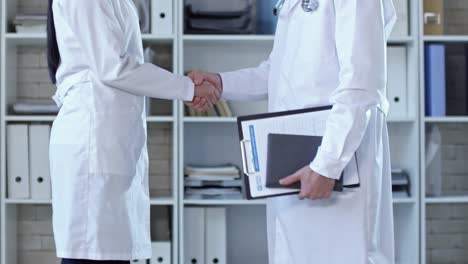 Doctors-in-Lab-Coats-Shaking-Hands