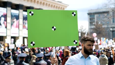 European-people-at-demonstration.-Man-with-a-banner-screaming-into-a-mouthpiece.