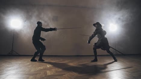 Medieval-warriors-are-fighting-during-sword-battle-indoors-in-slow-motion