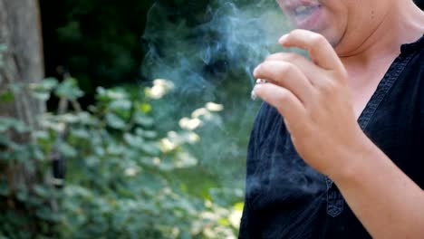 unknown-man-smoking-a-cigarette-and-coughing.