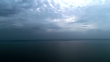 The-flight-above-the-picturesque-sea-on-the-rainy-cloud-background.-time-lapse