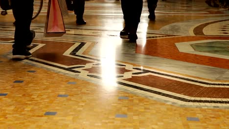 Scurrying-people-crowd-legs-and-floor-view-in-Galleria-Vittorio-Emanuele-II,-Milan,-Italy