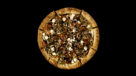 Rotating-pizza-with-smoked-sausage-and-olives-on-a-black-background.-Top-view-center-orientation