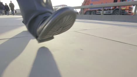 Low-angle-view-of-a-business-man's-feet-walking