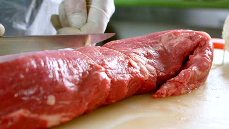 Butcher-tying-meat-with-thread-in-shop-4k