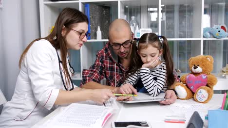 Father-with-his-little-daughter-at-the-reception-at-the-family-doctor-in-the-clinic.