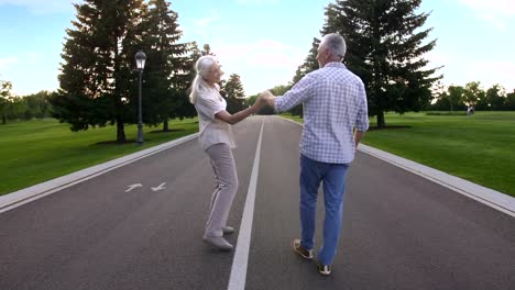 Young-at-heart-couple-on-a-cheerful-walk-outdoors