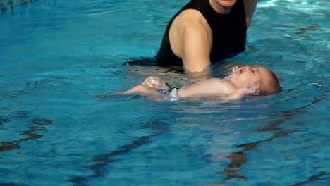 Coach-teaching-baby-to-swim