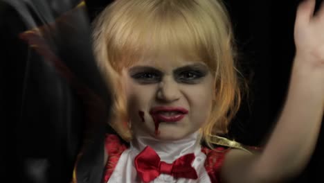 Dracula-child.-Girl-with-halloween-make-up.-Vampire-kid-with-blood-on-her-face