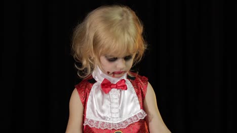 Dracula-child.-Girl-with-halloween-make-up.-Vampire-kid-with-blood-on-her-face