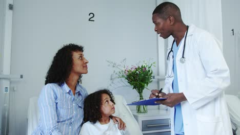 Front-view-of-African-american-male-doctor-doing-routing-check-up-in-the-ward-at-hospital-4k