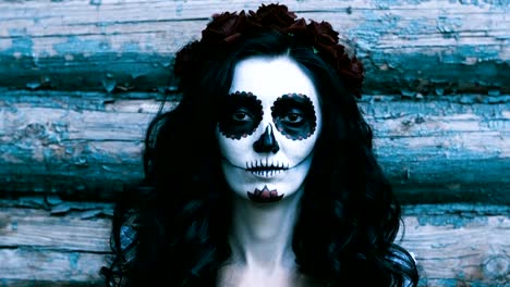 Die-junge-Frau-mit-Make-up-für-Halloween-auf-dem-Hintergrund-der-Holzwand.-4K