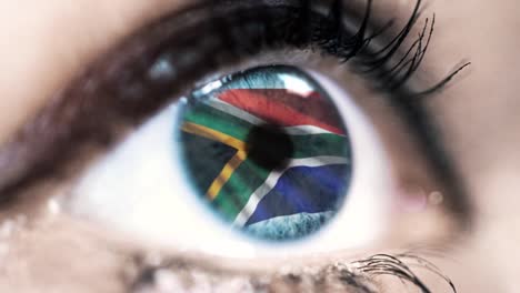 woman-blue-eye-in-close-up-with-the-flag-of-south-africa-in-iris-with-wind-motion.-video-concept