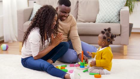 african-family-playing-with-baby-daughter-at-home